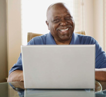 image of smiling senior man on laptop
