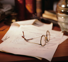 image of papers and eye glasses