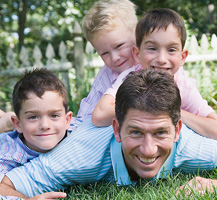 image of smiling dad and kids