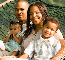 image of smiling family on hammock