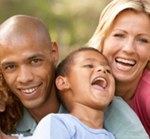 image of smiling parents and kid