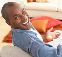 image of smiling man on couch