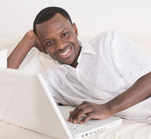 image of smiling man using laptop