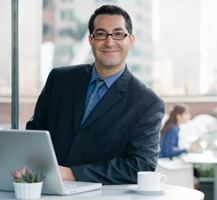 image of smiling business man on laptop