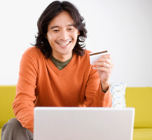image of smiling man using credit card